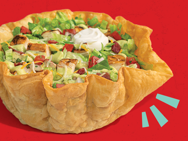 Avocado Ranch Chicken Taco Salad in a crispy tortilla bowl with grilled chicken and fresh toppings.